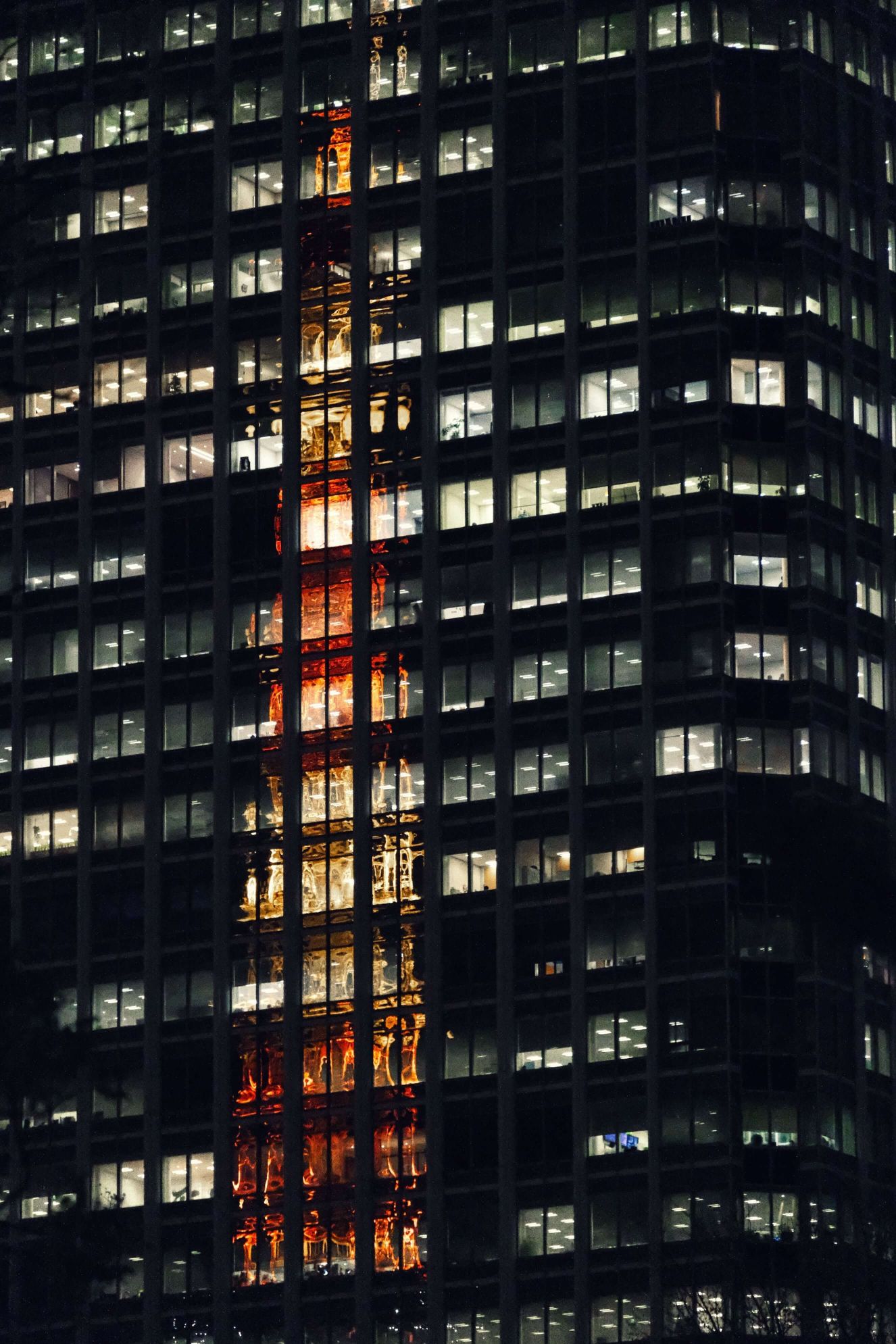 Have you ever seen a reflection of a tower so unique? The Tokyo Tower looks like a fire inside this black building.